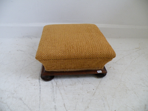 A newly re upholstered 19th century footstool on mahogany bun feet