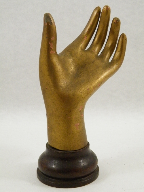 An original early 20th century Art Deco shop display hand, carved wood, gesso and gold painted