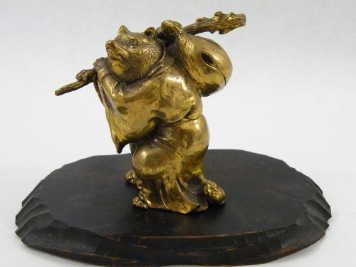 An Oriental gilt bronze statue of a Tanuki figure - mythical fox in cloak  - possibly Japanese Meiji