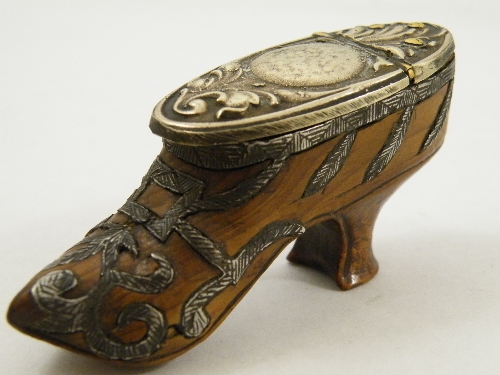 An unusual yew wood snuff box in the shape of a shoe with applied metal decoration and cover-