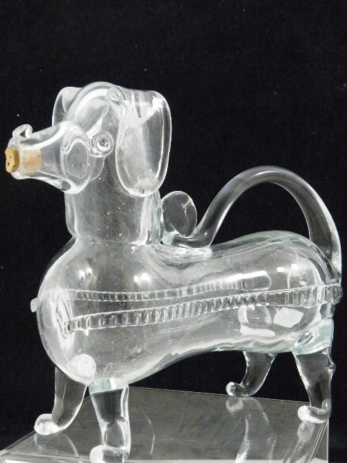 An Edwardian reproduction of an 18th century glass novelty whiskey decanter in the form of a dog