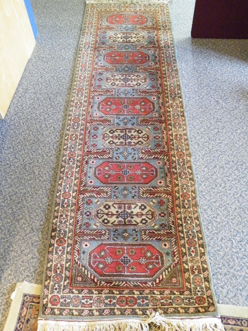 An early 20th century Afghan or Persian hallway runner/rug of repeat geometric panels enclosed