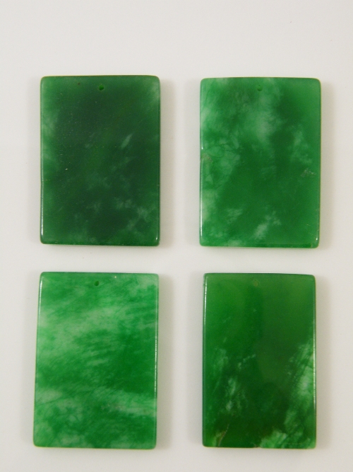 Four Chinese apple green rectangular pendants 5cm x 3.5cm