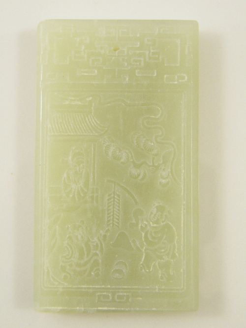 A large Chinese Celadon pendent carved to two sides - one side with Chinese text the other side with