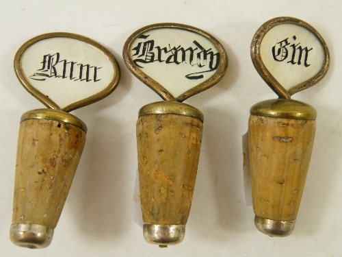 Three late 19th/ early 20th Century cork bottle stoppers with silver plated mounts and mother of