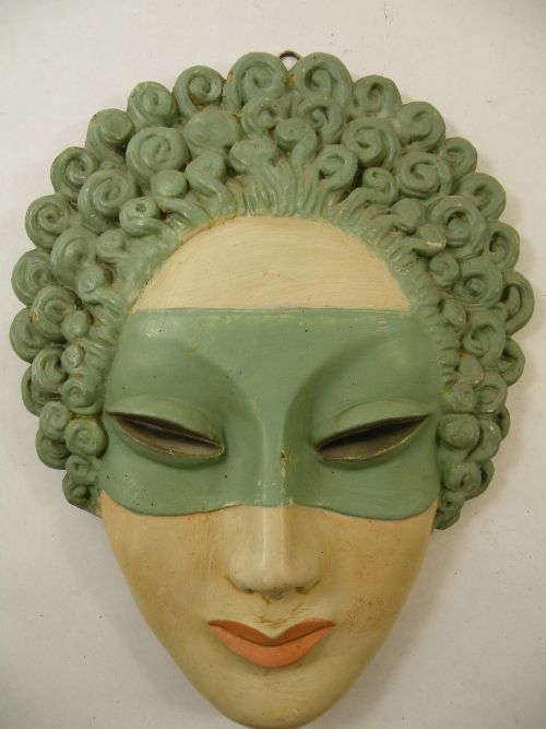 An unusual Art Deco wall mask of a Venetian masked female, bronze or brass with painted finish -