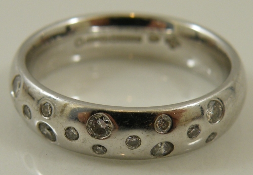 A Goldsmiths & Silversmiths  18ct white gold and diamond studded band  with CG&S mark - size O - 7g