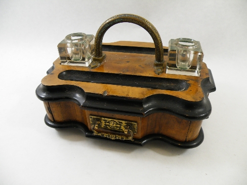 A Victorian walnut & ebonised desk stand with brass hoop handle, fitted drawer & brass drop handle