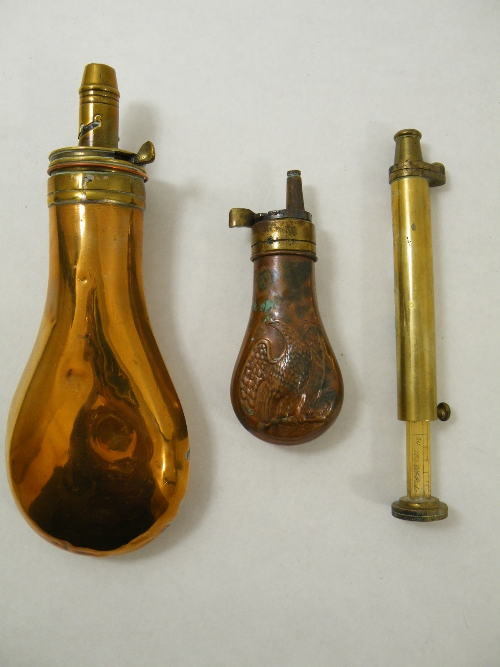 A copper & brass powder flask, the top stamped PATENT, a smaller flask with an embossed eagle design