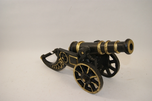 A cast metal cannon with painted gilt decoration 45cm long