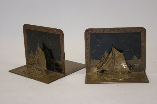 Pair of brass or bronze Art Deco style bookends of Oriental boats with engraved and enameled