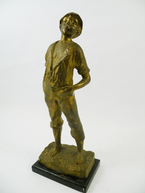 Early 20th C gilded spelter figure of a young boy  with hands in pockets on ebonised wooden