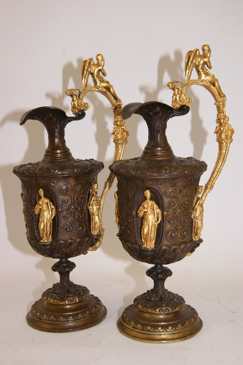 Fine pair of late 19th C bronze candle holders styled as Classical pourers with architectural