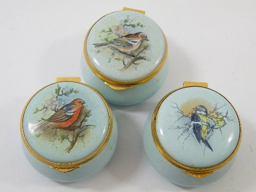 Three Staffordshire Enamels round pill boxes : each decorated with garden birds to the lid and inner