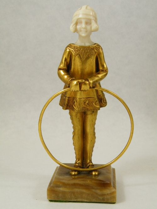 Art Deco gilt bronze and ivory figure of a girl with hoop - carved ivory face and mounted on brown