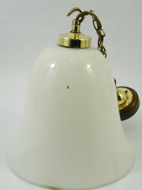 An Art Deco style milk glass bell-shaped pendant light fitting with brass chain and hooks 30cm high