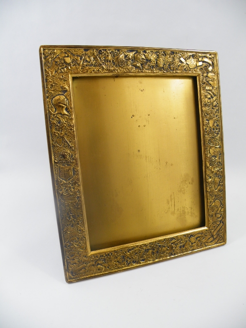 A gilt bronze mirror / picture frame with heraldic boarder, stamped to the rear Favrile, Louis C