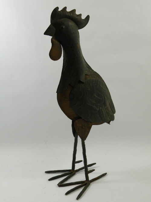 A vintage formed metal folk art cockerel with traces of original painted decoration, possibly