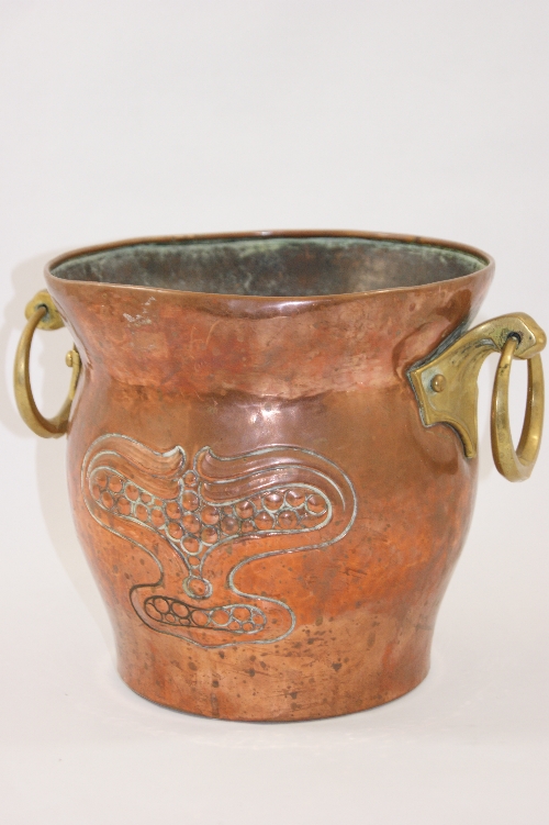 A large hammered copper Arts & Crafts cooler or jardiniere with hand beaten pomegranate decoration