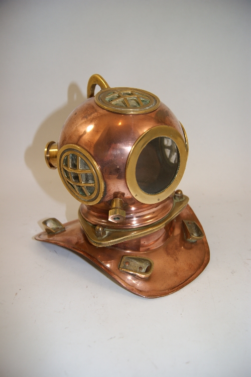 A miniature copper and brass divers helmet. 19cm high