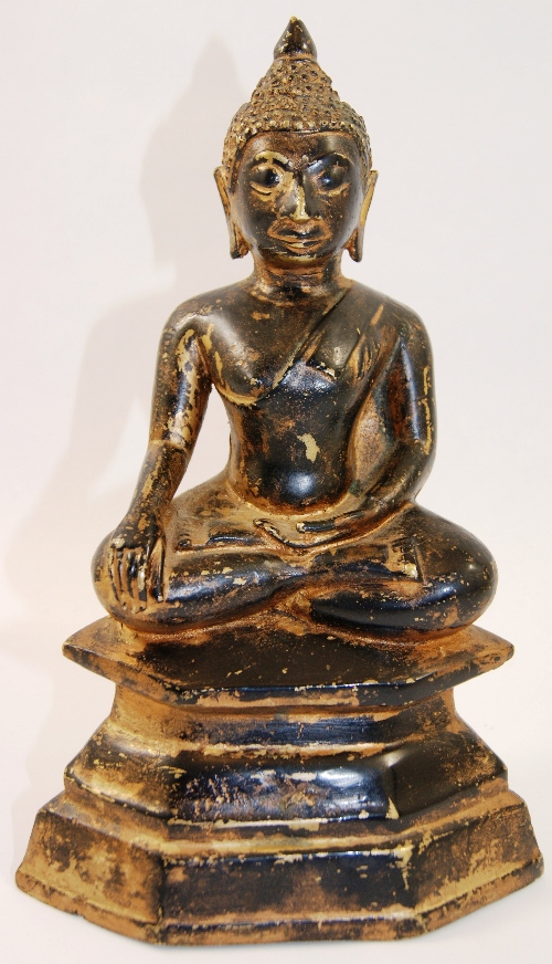 A Tibeto-Chinese figure of Buddha seated with legs crossed on a double lotus, the serene face with