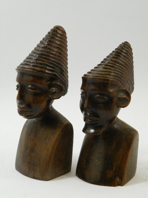 A pair of African native made carved hardwood portrait busts 13cm high