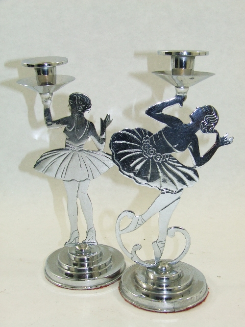 A pair of Art Deco period chrome candlesticks, modelled as jazz age dancers, supported on stepped