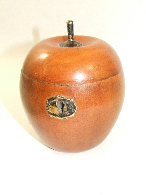 A wooden tea caddy in the form of an apple 14cm high