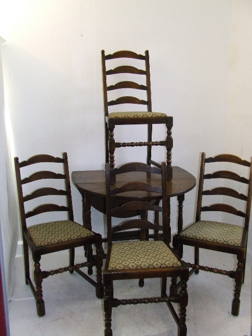 Oak drop leaf dining table and four oak ladder back chairs with bobbin turned stretcher