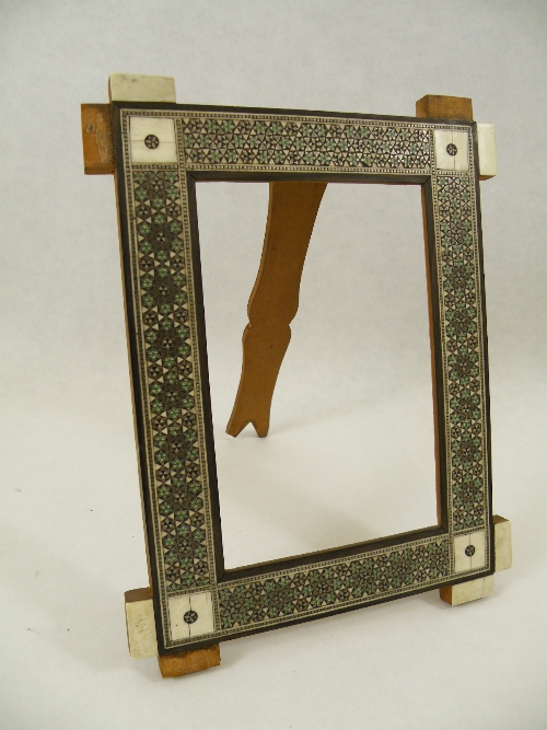A 19th Century Indian ivory mounted and Sadeli work picture frame, having reticulated panels. 19cm x