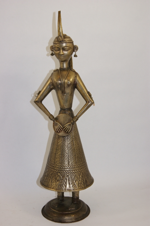 A gilt metal figure of a female deity with drum - wearing a elaborate headdress and jewellery