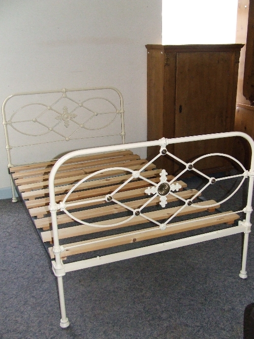 Victorian cast iron small double bed with applied brass mounts to foot with pine slats 123cm w