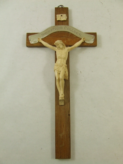 An early 20th C oak crucifix with a cast plaster Corpus Christie and a plated metal plaque inscribed