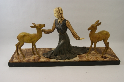 A large Art Deco spelter and ivorine figure with central female with gilded and cold painted