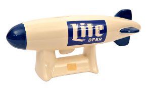 A China Airship Money-box - “Lite Beer”. A moulded china airship money box in creamy white and