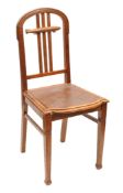 A German upright dining chair. An arched backed wooden chair with 3 central back supports