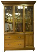 A large cabinet converted to hold eleven longarms, height 90” x 54” x 13” depth, upper half glazed