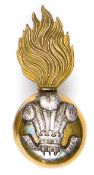 An Officers’ gilt and silver plated fur cap grenade badge of The Royal Welsh Fusiliers, with screw