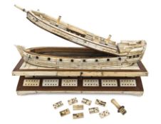 A bone on wood games box in the form of a waterline model of the hull of a Napoleonic period 2