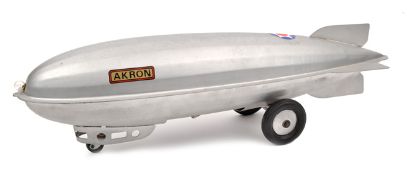A scarce American Steelcraft large heavy duty tinplate push-pull along ‘Akron’ airship toy. 63cm.