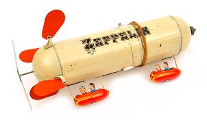 An unusual tinplate ‘Zeppelin’ toy. Probably 1930’s American finished in cream with ‘Zeppelin’ in