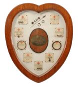 An impressive heart shaped wood framed and glazed display of salvaged wire from the airship SL11