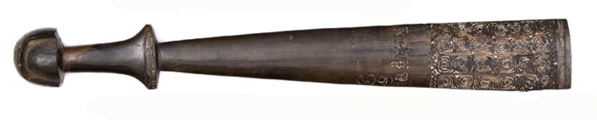 A New Guinea dark wood “sword” club, 26½” overall, the broad spatulate blade carved with a broad
