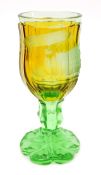A cut glass goblet. 20cm high in deep yellow and green glass with frosted scene of an early Parceval