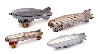 4 small heavy cast metal airship toys. ‘Graf Zeppelin’ 17cm. American style airship on wheels 15.5cm