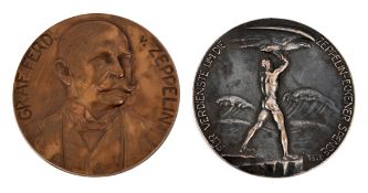 2 large German Zeppelin medallions. 8.3cm in silvered bronze, naked man launching an eagle with