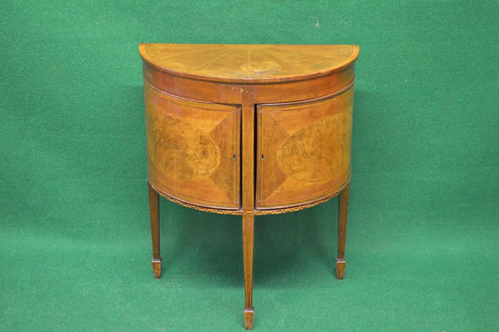 A mahogany inlaid demi lune night stand having inlaid and cross banded top over pair of string