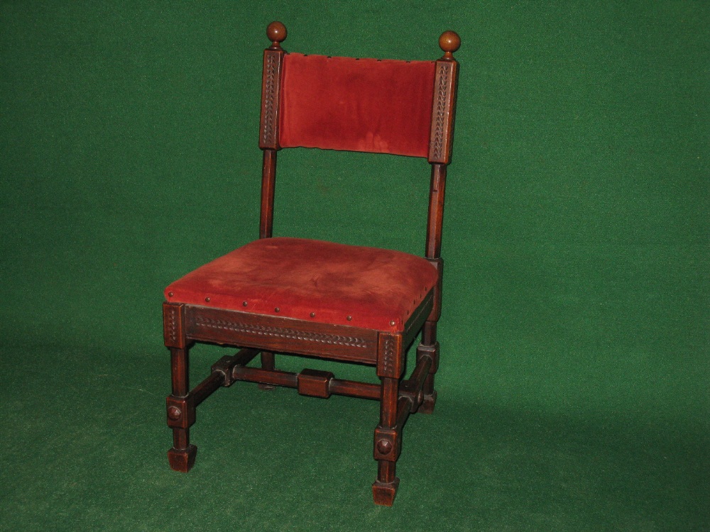 An oak framed hall chair having open back with padded top rail supported by octagonal and carved