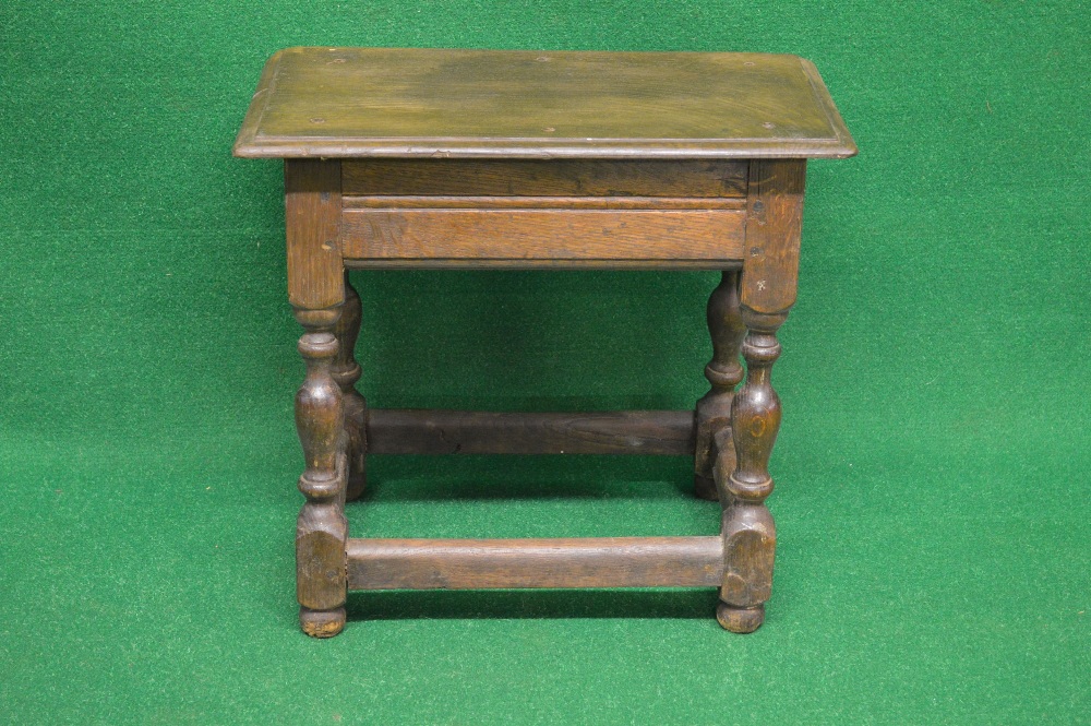 An oak joint stool having rectangular top with moulded edge, supported by turned legs and mounded