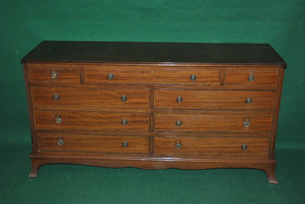 A mahogany chest of nine drawers comprising of a central long top drawer flanked by two short